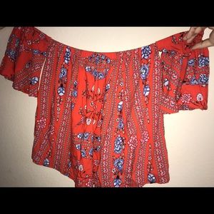 An orange floral off the shoulder shirt